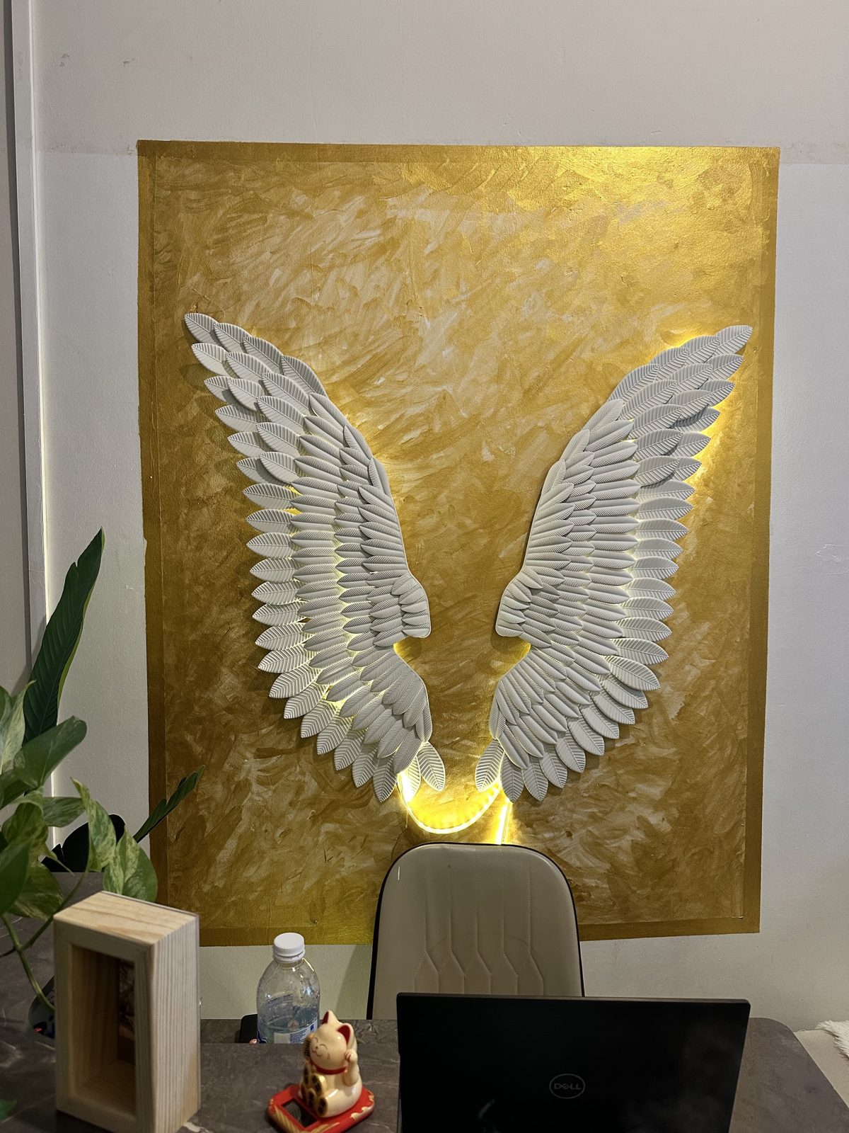 The angel wings artwork on the studio wall
